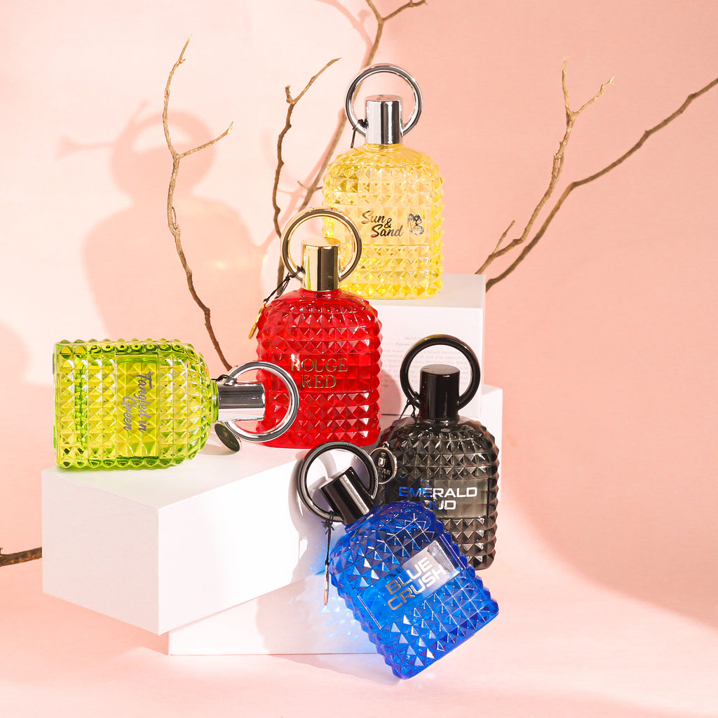 Display of colorful perfume bottles including Sun And Sand Perfume by Lyla Blanc, showcasing a vibrant collection.