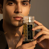 Tobacco Vanilla Eau De Parfum in a stylish bottle held by a model, reflecting sophistication and allure.