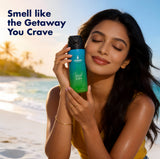 Model holding Urban Scent Island Water Deodorant body spray on a beach, promoting a refreshing, aquatic scent