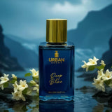Urban Scent Deep Blue Eau de Parfum bottle against a misty ocean backdrop with flowers.
